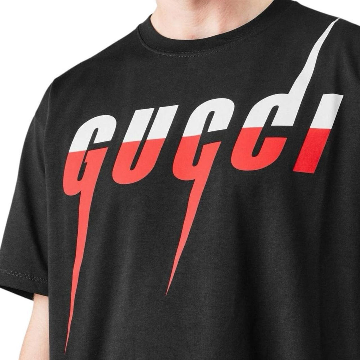 Black and red designer item with tags, featuring a logo and premium material.