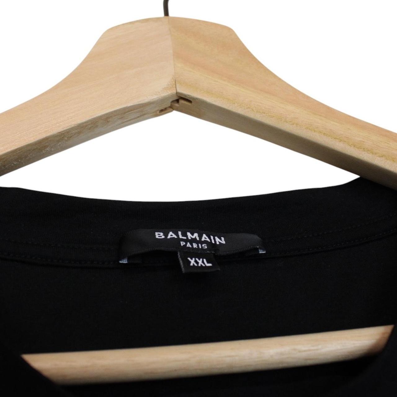 Balmain black pocket t-shirt with white embroidered logo and short sleeves.