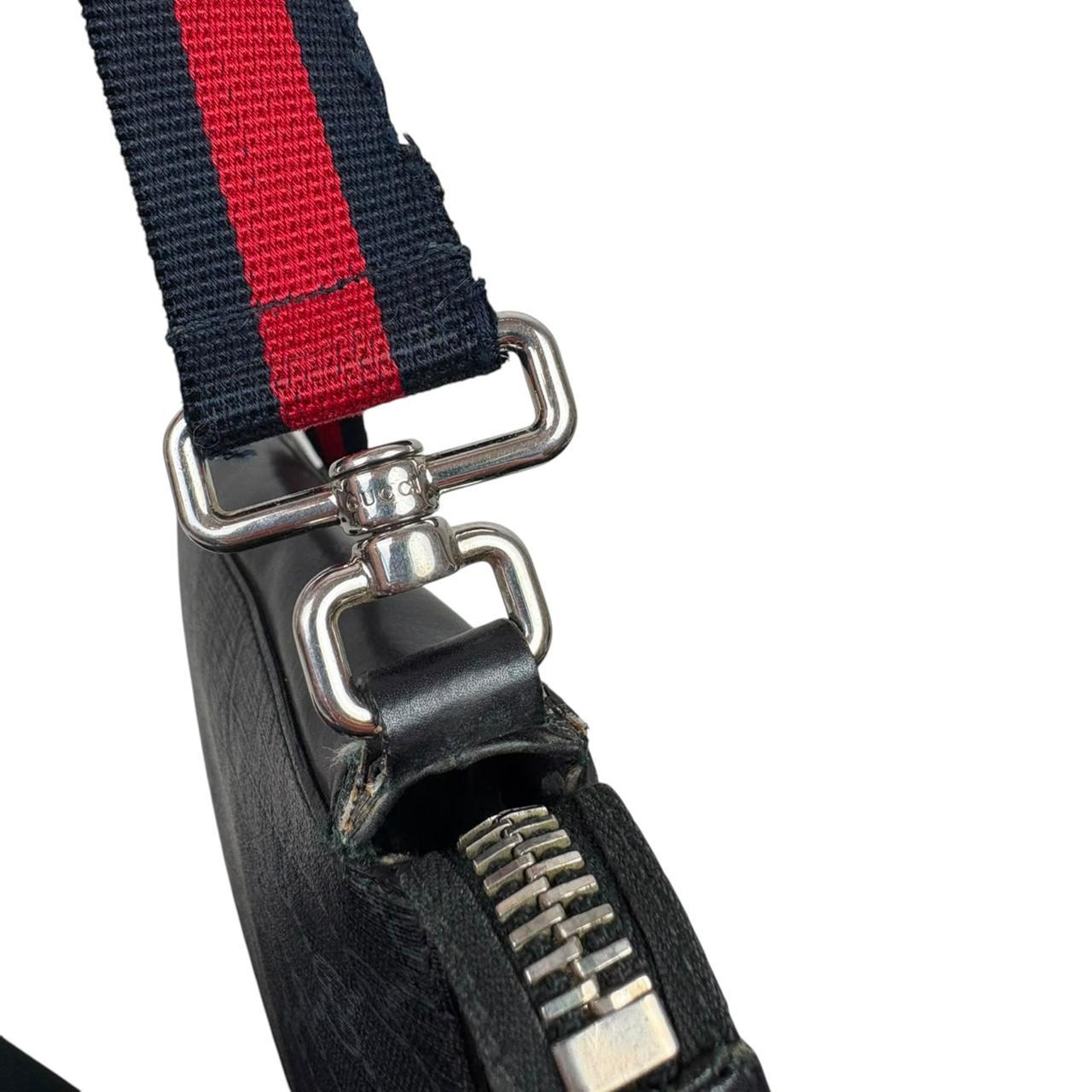 Gucci black duffel bag featuring GG Supreme monogram pattern and adjustable strap.