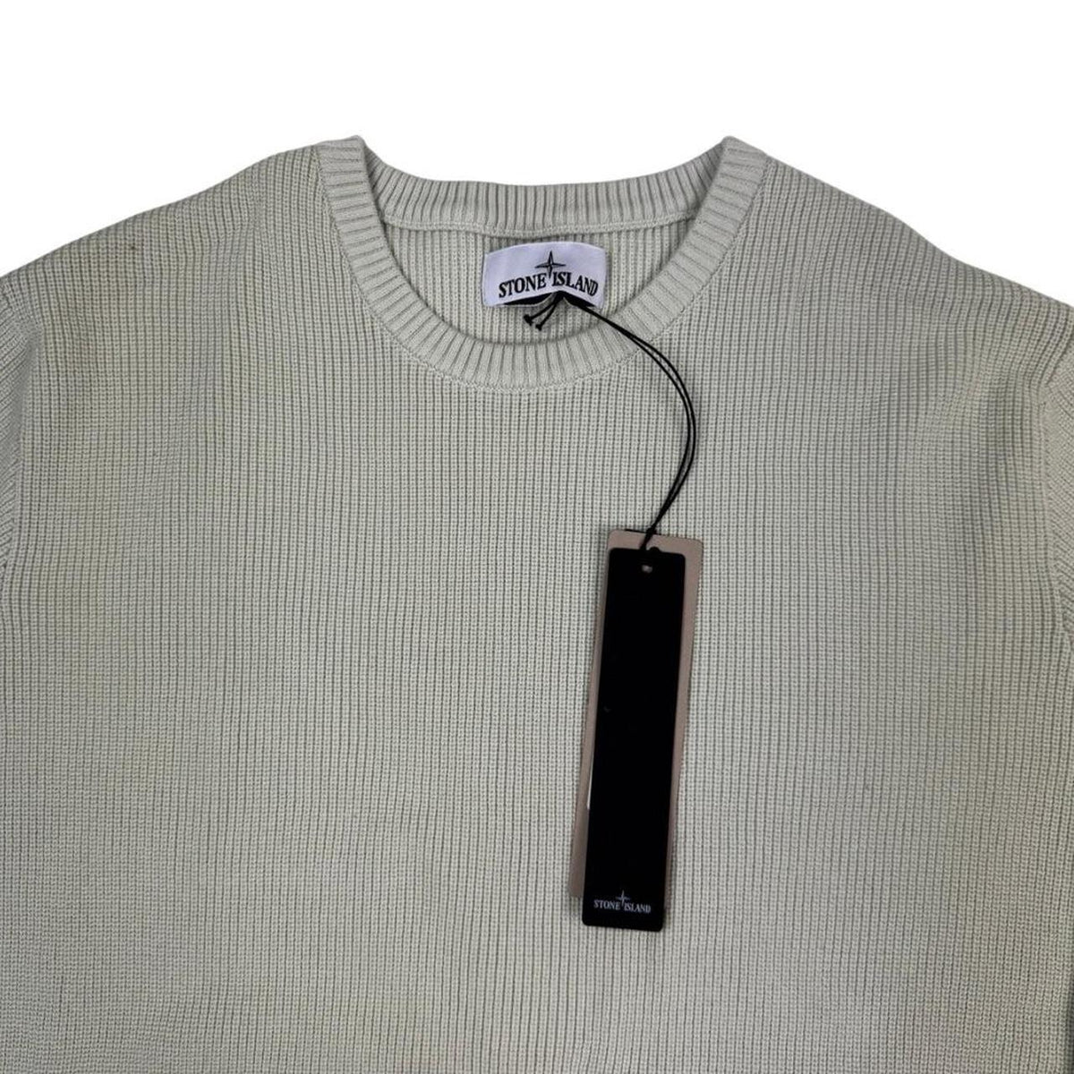 Stone Island beige waffle knit jumper with logo patch and organic cotton material.