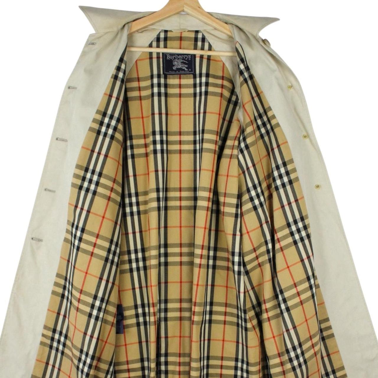 Burberry beige trench coat featuring iconic Nova Check pattern and single breasted design.