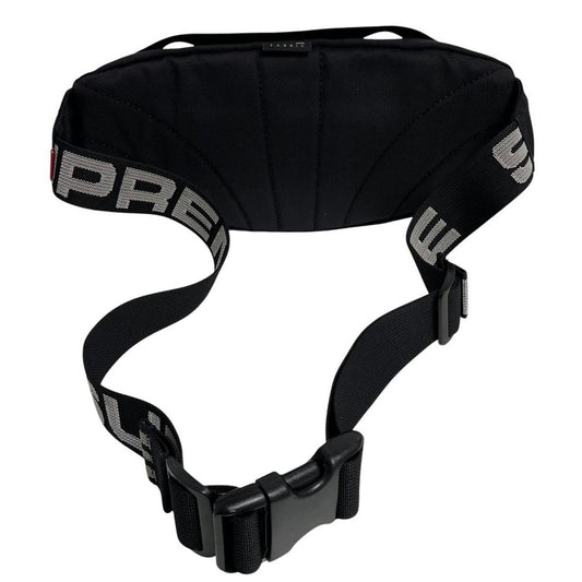 Supreme black waist bag featuring logo print and durable material.