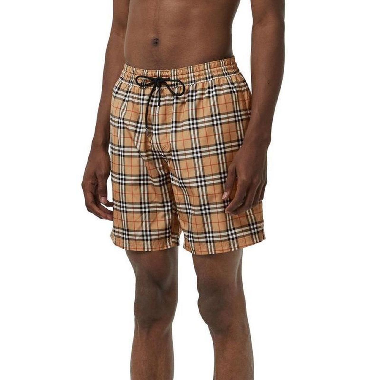 Burberry beige swim shorts featuring Nova Check pattern and nylon material.