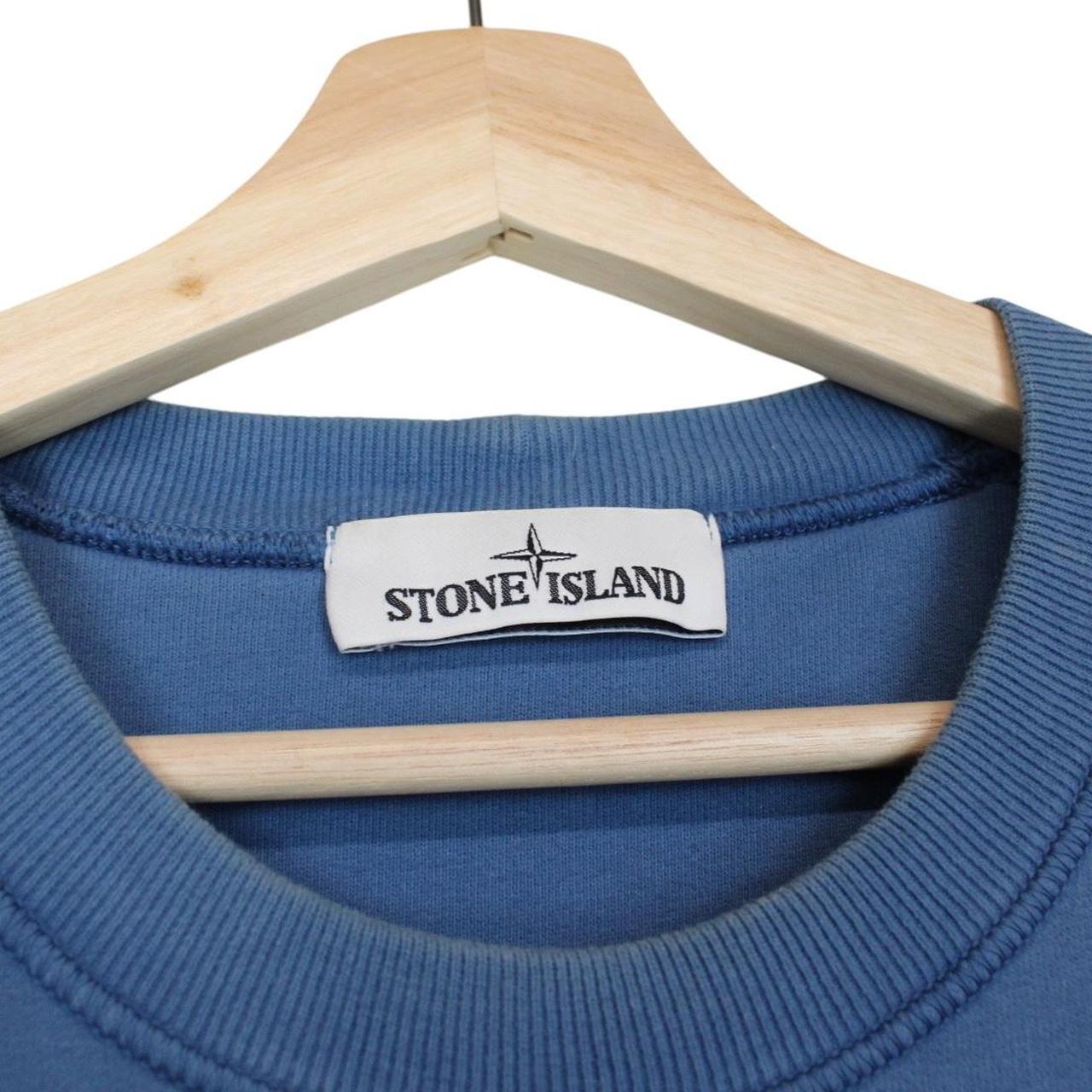 Stone Island blue cotton sweatshirt with iconic compass logo and ribbed cuffs.