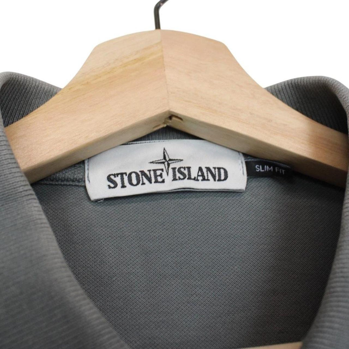 Stone Island grey polo shirt with embroidered compass logo and cotton material.