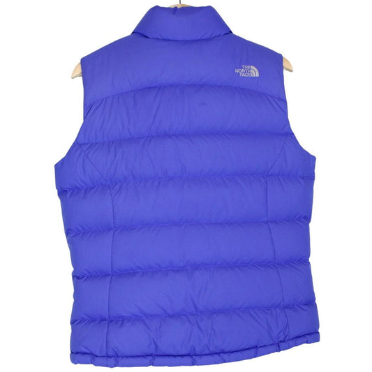 The North Face blue down gilet with logo detail and quilted pattern.
