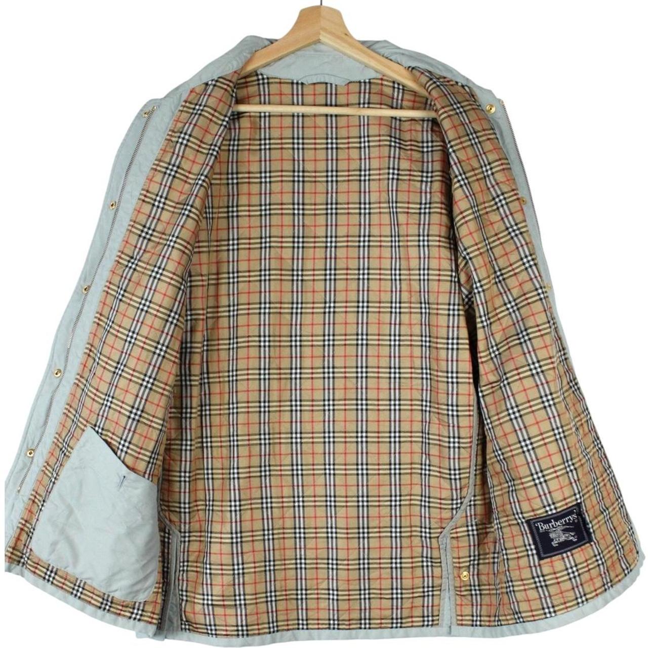 Burberry light blue diamond quilted jacket with Nova Check pattern and logo detail.