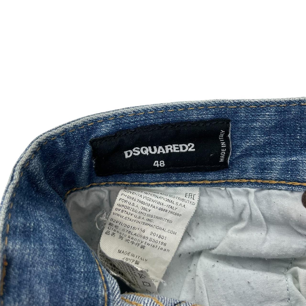 Dsquared2 blue straight jeans with distressed details and logo patch on back pocket.