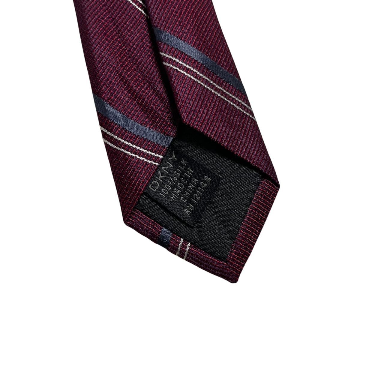 DKNY plum purple silk tie with a smooth finish and vintage design.