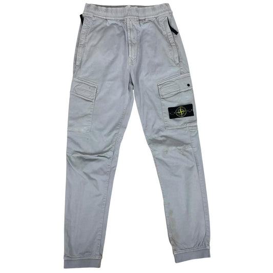 Stone Island blue cargo trousers with logo patch and RE-T fit, visible stain on left leg.