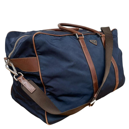 Prada navy blue and brown nylon duffel bag with signature logo and minimal wear.