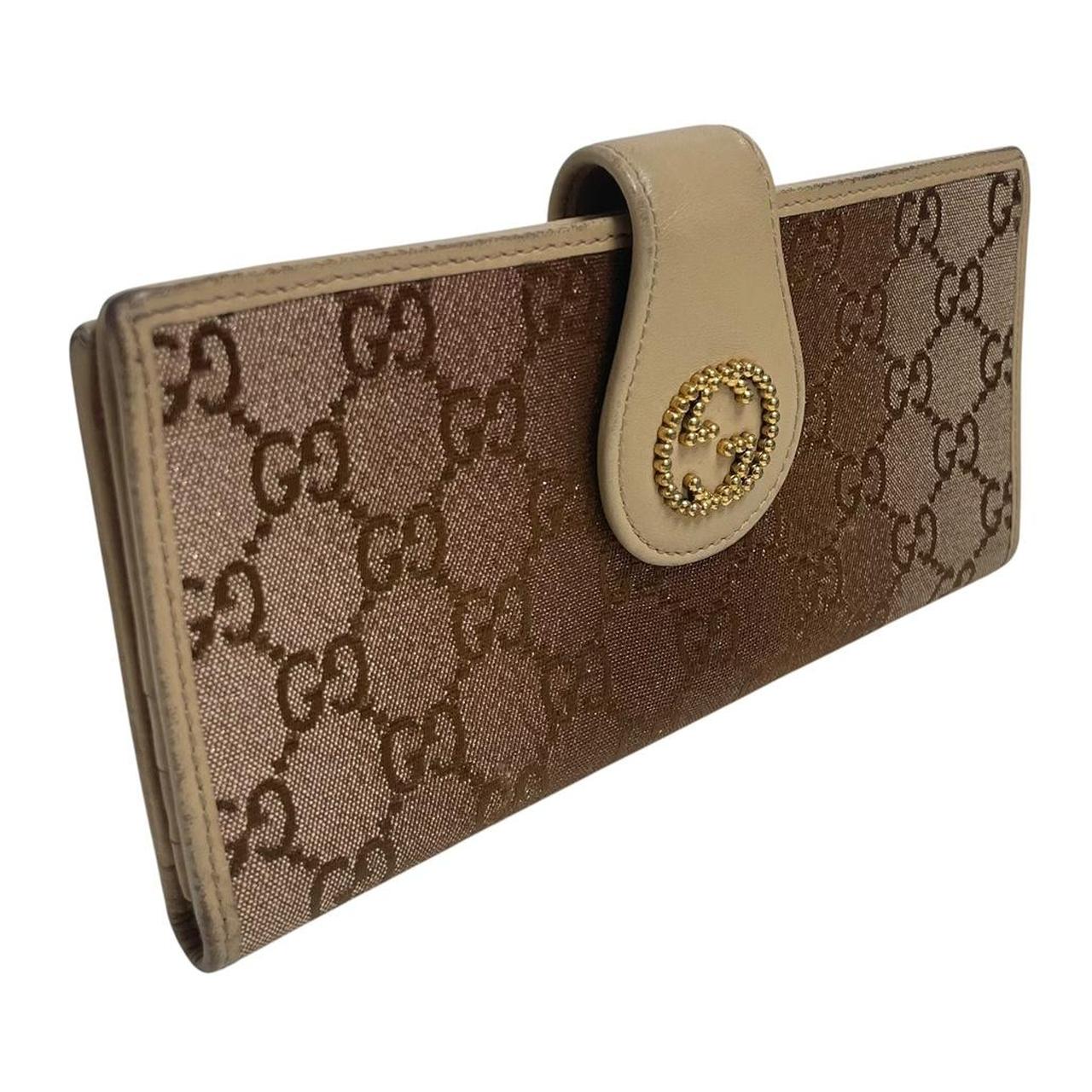 Gucci beige and pink GG monogram continental wallet with logo and wear details.