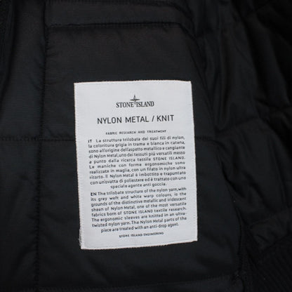 Stone Island black jacket with special process badge and full zip design.