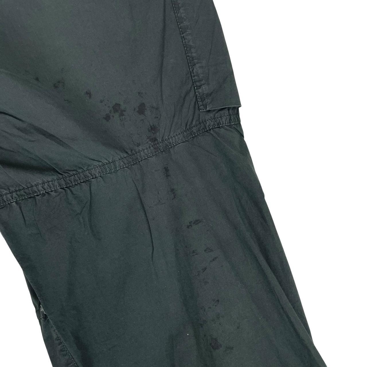 Stone Island grey cargo trousers with logo patch and loose stitch detail.