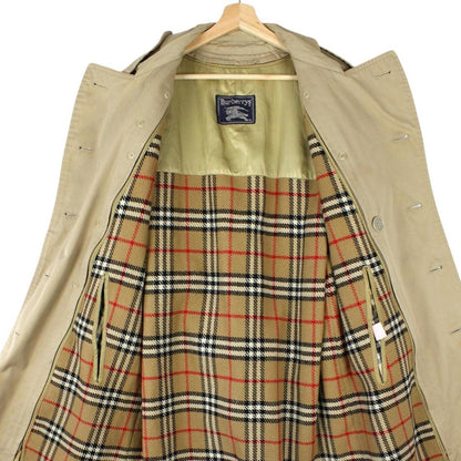 Burberry beige trench coat with Nova Check pattern, double-breasted and belted design.
