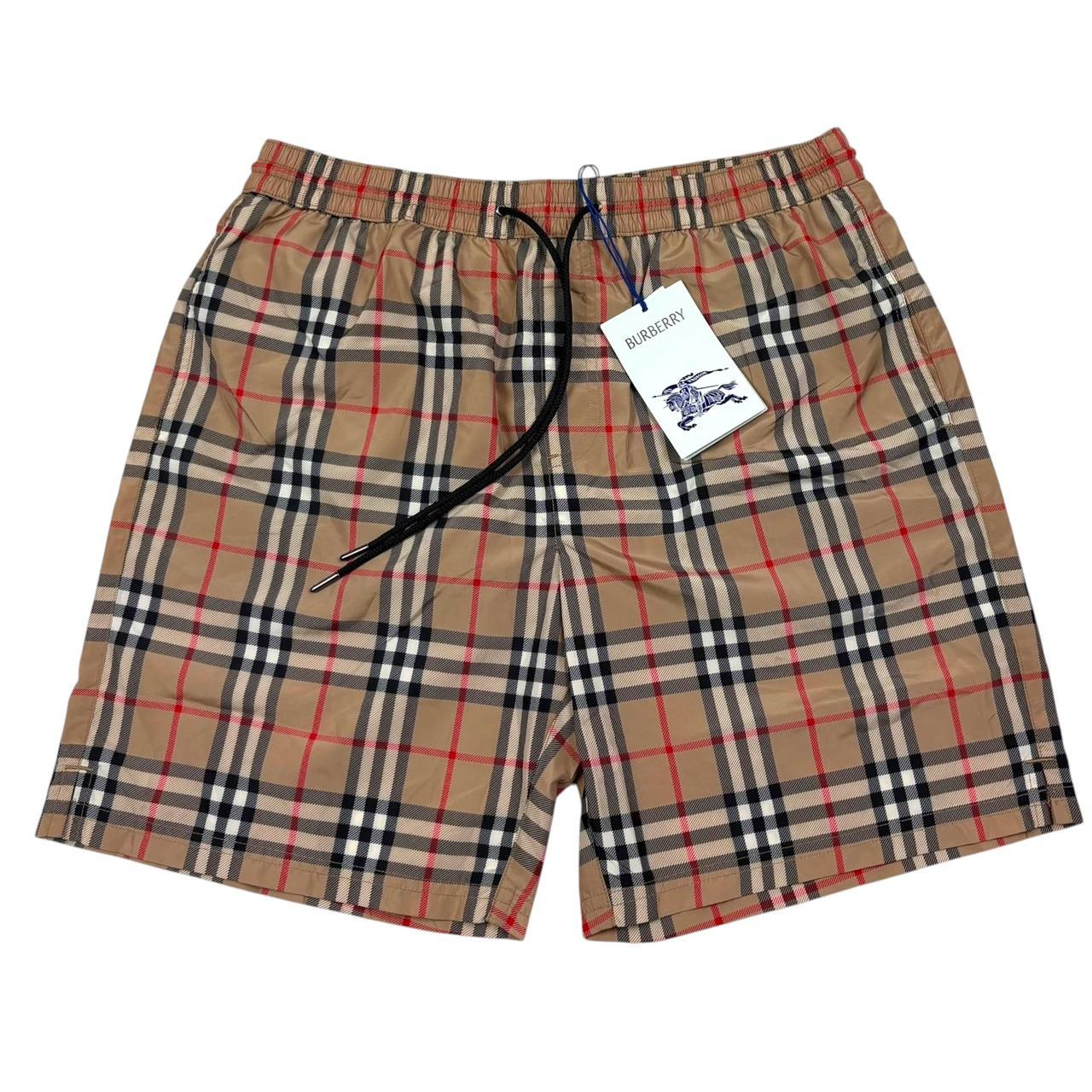Burberry beige swim shorts featuring Nova Check pattern and nylon material.