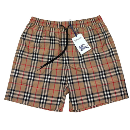 Burberry beige swim shorts featuring Nova Check pattern and nylon material.
