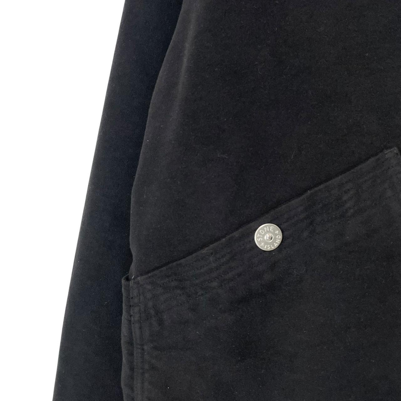 Stone Island navy blue work jacket with detachable compass badge and button-down closure.