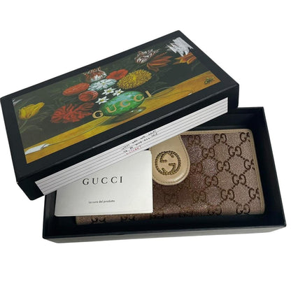 Gucci beige and pink GG monogram continental wallet with logo and wear details.