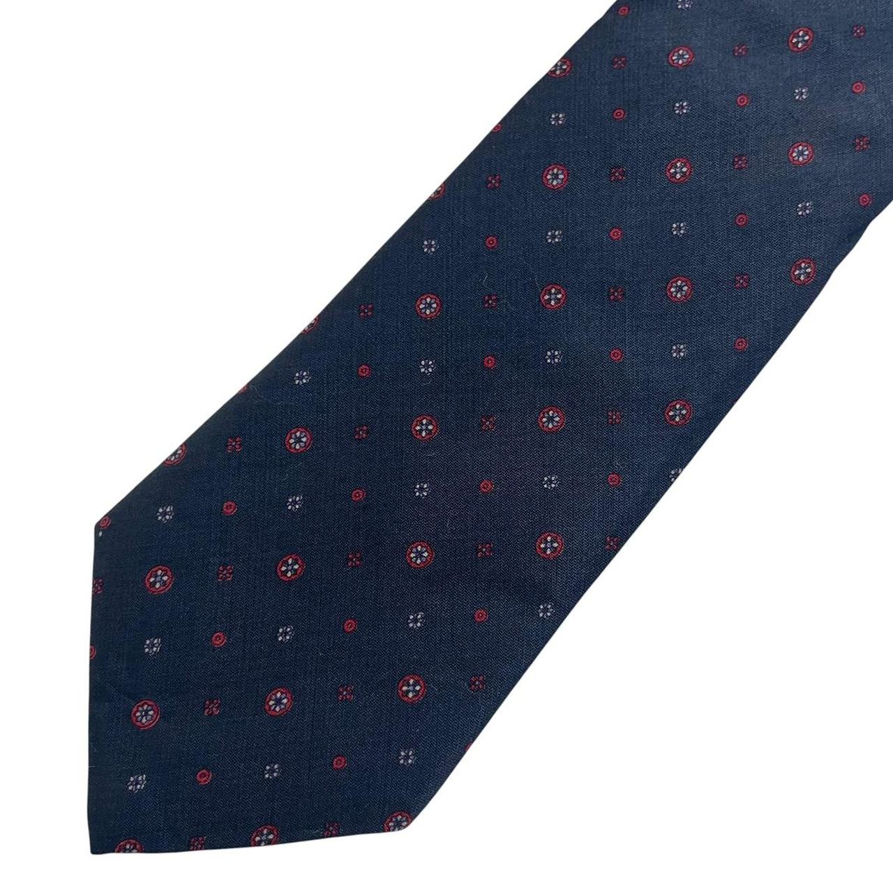 Yves Saint Laurent navy blue silk tie with subtle sheen and classic design.