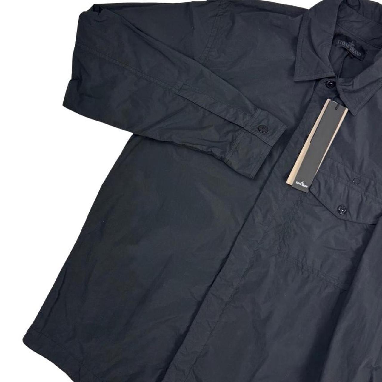Stone Island black nylon overshirt jacket with ghost logo and smooth texture.