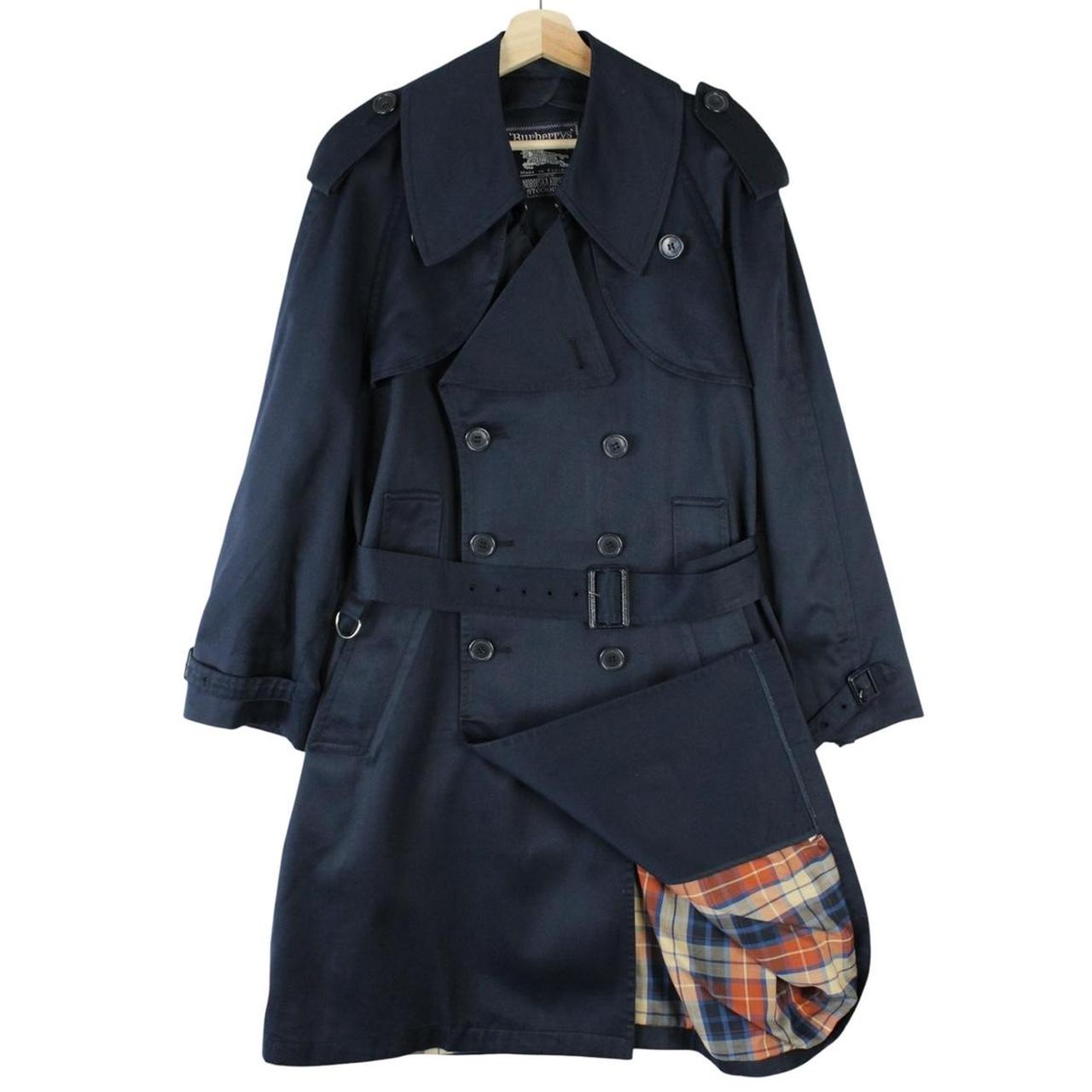Burberry navy blue double breasted trench coat with belted waist and classic check lining.