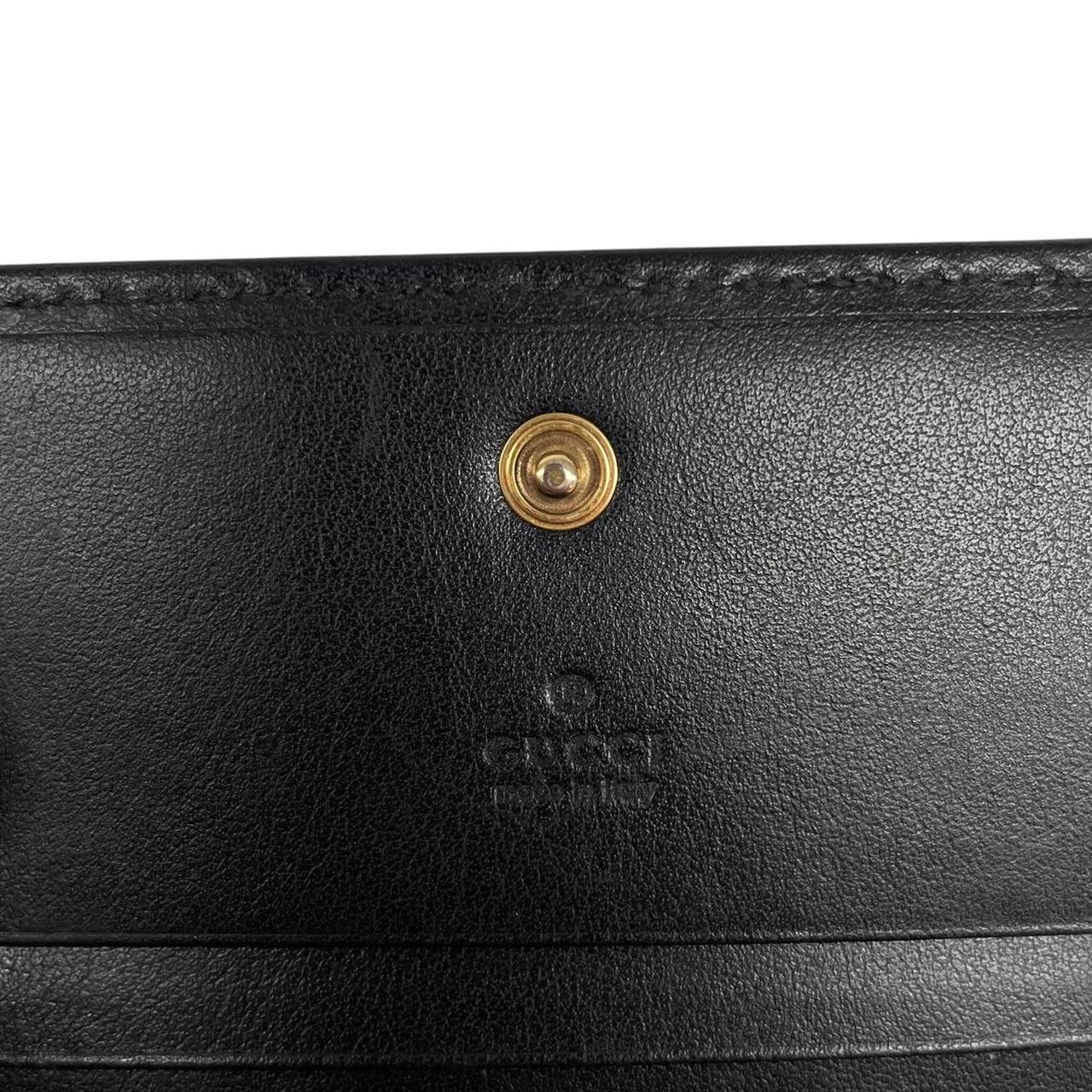 Gucci black calfskin card case wallet with matelasse pattern and GG logo.