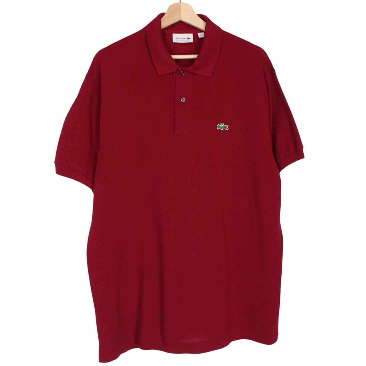 Lacoste burgundy polo shirt with embroidered crocodile logo and pocket detail.