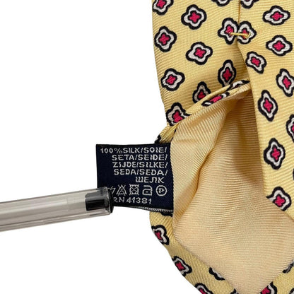 Polo Ralph Lauren yellow silk tie with geometric print design and logo detail.