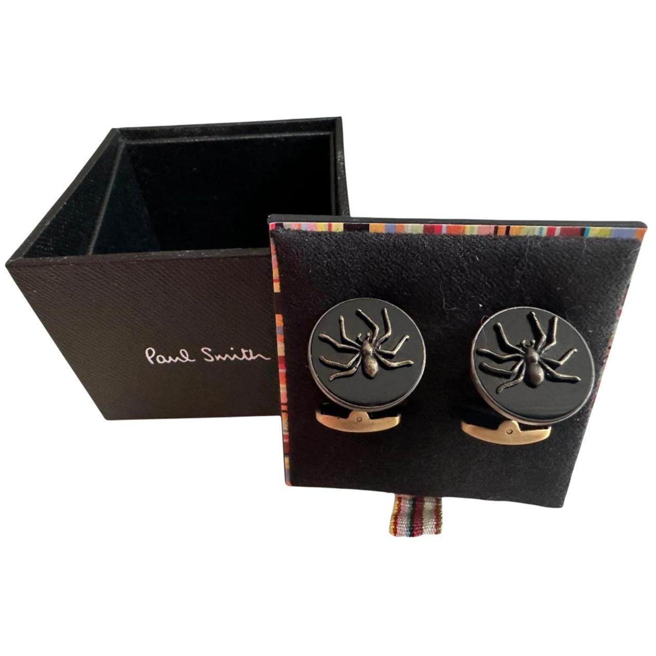 Paul Smith gunmetal cufflinks 2D spider design with intricate detailing and brand logo.
