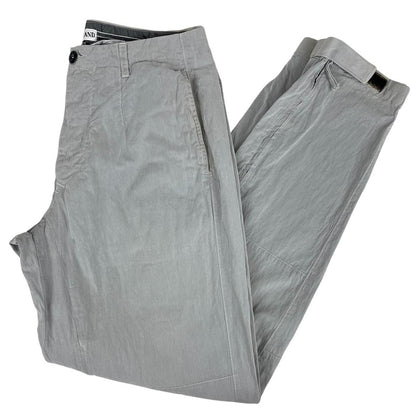 Stone Island grey tapered fit trousers with logo patch and cotton material.