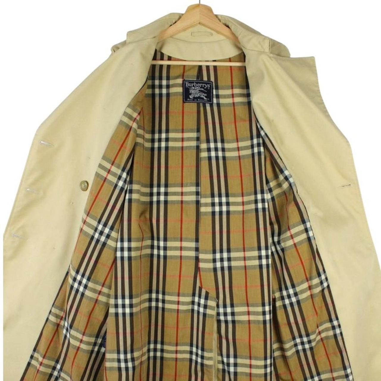 Burberry beige trench coat with Nova Check pattern, double-breasted and belted design.