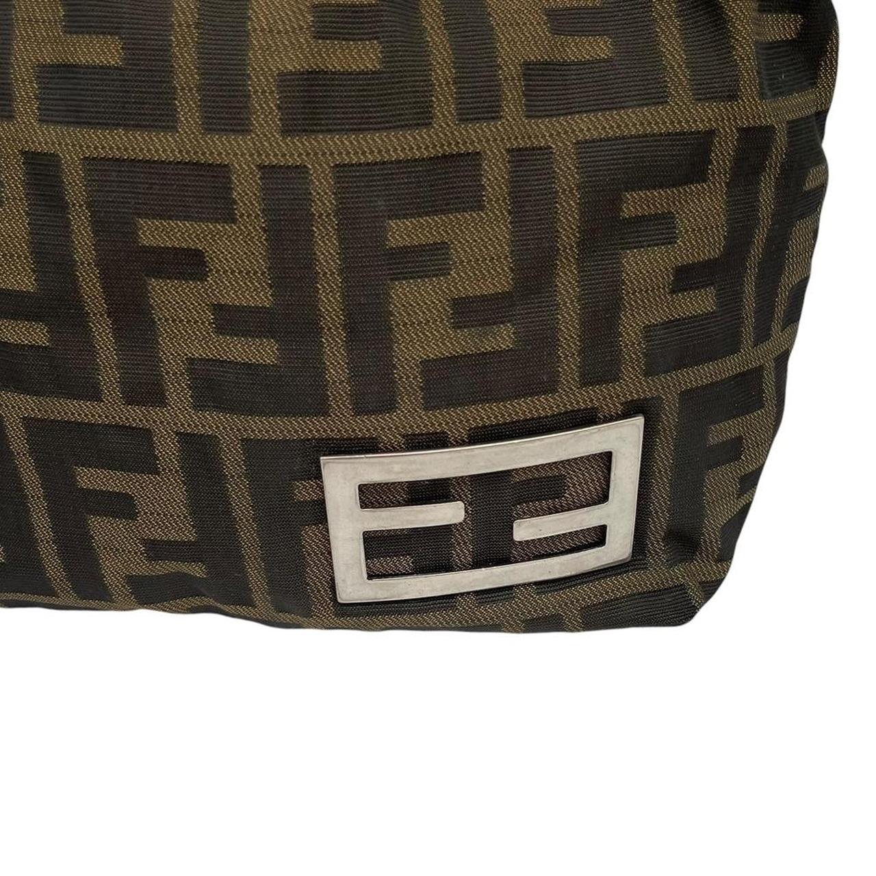 Fendi brown duffel bag featuring iconic Zucca monogram canvas and durable handles.