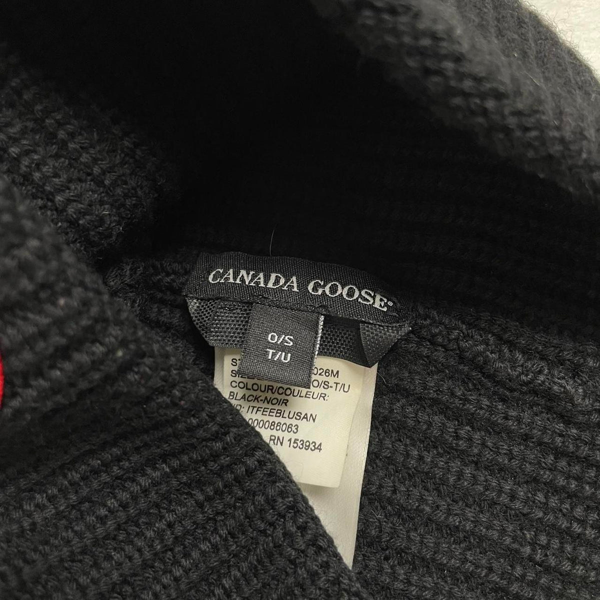 Canada Goose black ribbed wool beanie hat with logo patch on front.