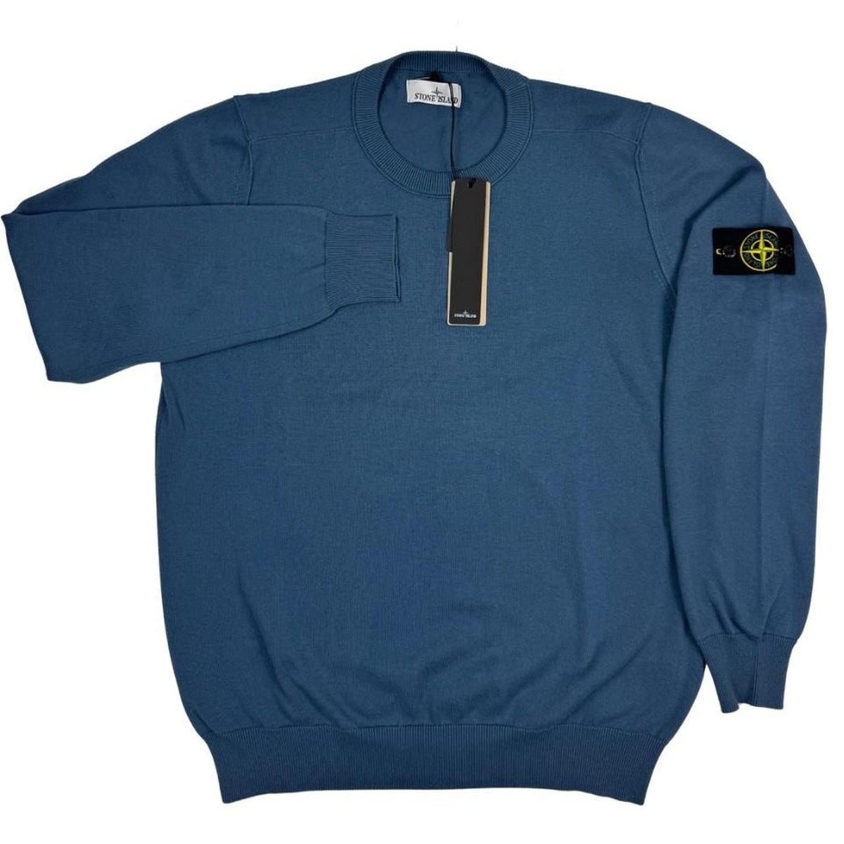Stone Island blue organic cotton knit jumper with logo patch and ribbed cuffs.