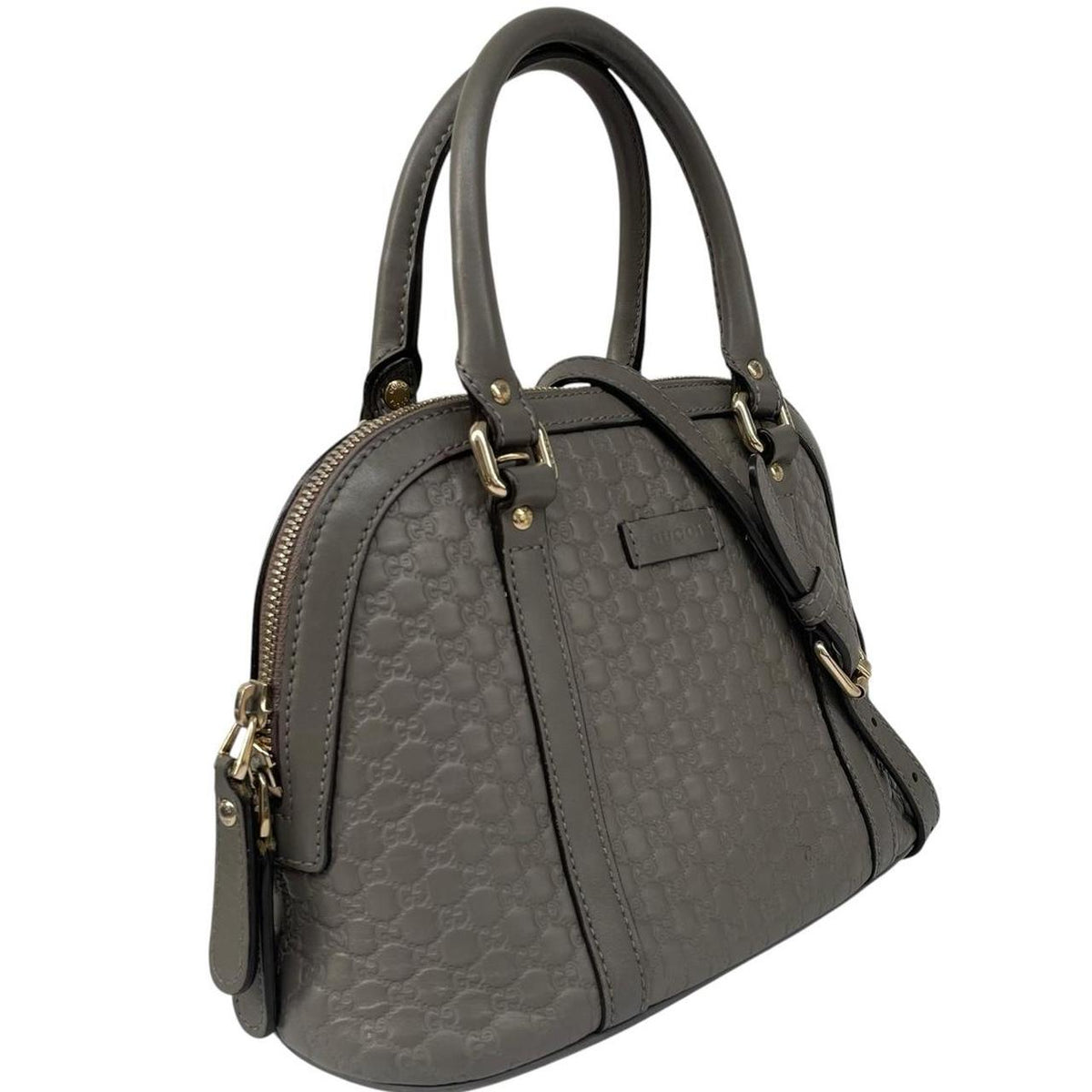 Gucci grey microguccissima mini dome shoulder bag with embossed logo and leather material.