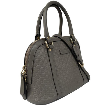 Gucci grey microguccissima mini dome shoulder bag with embossed logo and leather material.