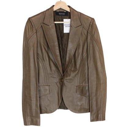 Gucci brown leather blazer jacket with logo detailing and classic tailored fit.