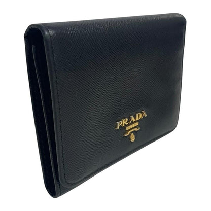 Prada black bifold wallet Saffiano leather with logo embossed detail.