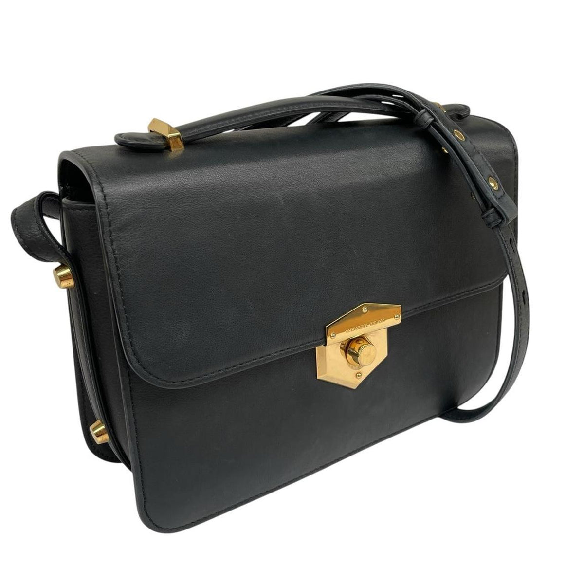 Alexander McQueen black and gold leather messenger bag with logo detailing and faint scratches.