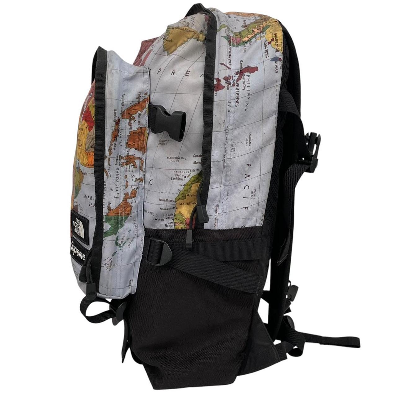 Supreme x The North Face black and multicoloured backpack with logo and scuffed base.