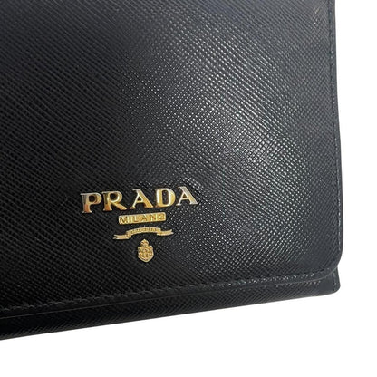 Prada black bifold wallet Saffiano leather with logo embossed detail.