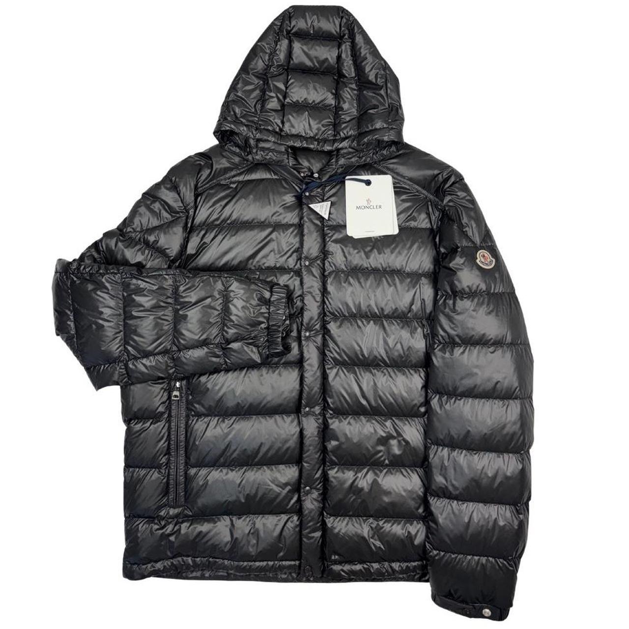 Moncler grey down nylon hooded puffer jacket with logo patch and quilted design.