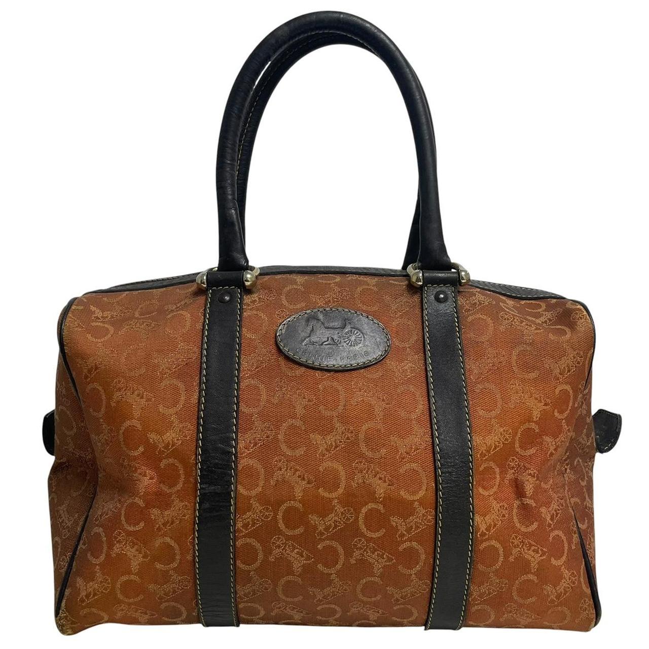 CELINE orange duffel bag with Macadam canvas and leather, visible wear and discolouration.