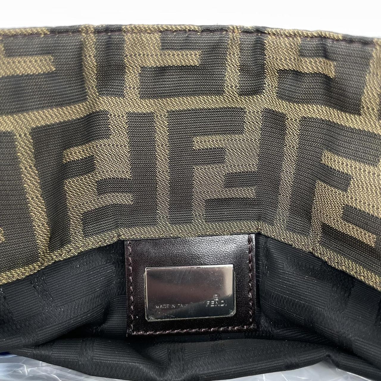 Fendi brown duffel bag featuring iconic Zucca monogram canvas and leather handles.