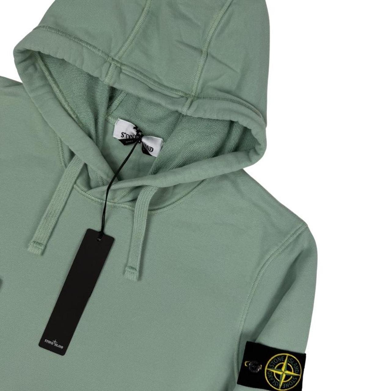 Stone Island green cotton hoodie with logo patch and drawstring hood.