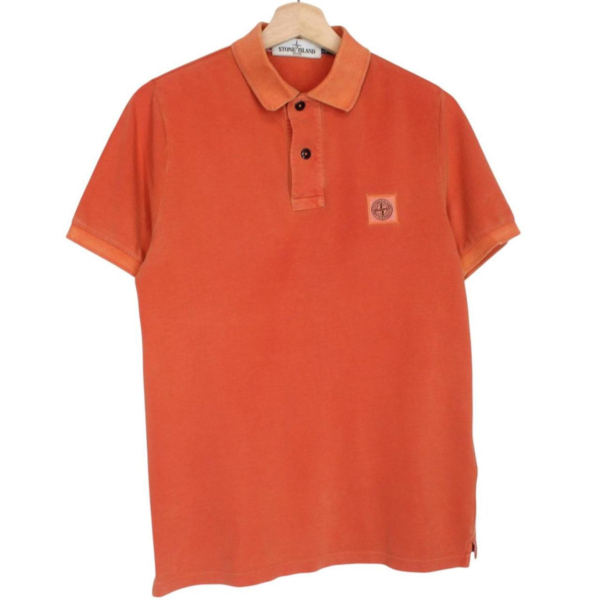 Stone Island orange short sleeve polo shirt with compass logo and cotton material.