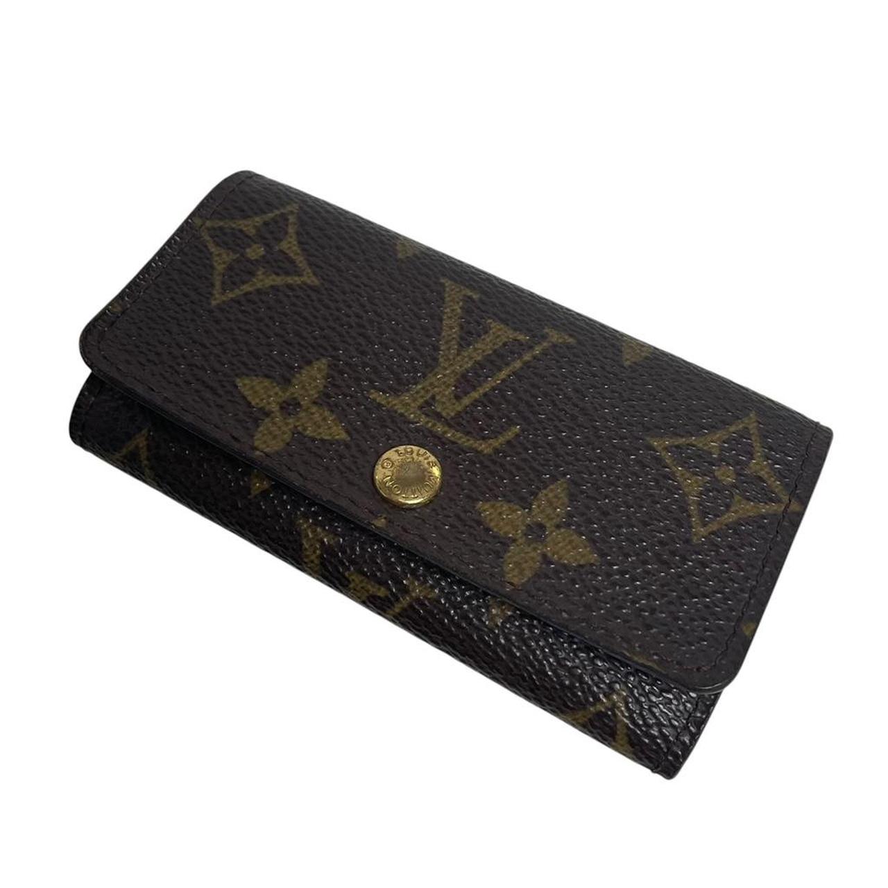 Louis Vuitton brown and tan monogram canvas key case with logo detail.