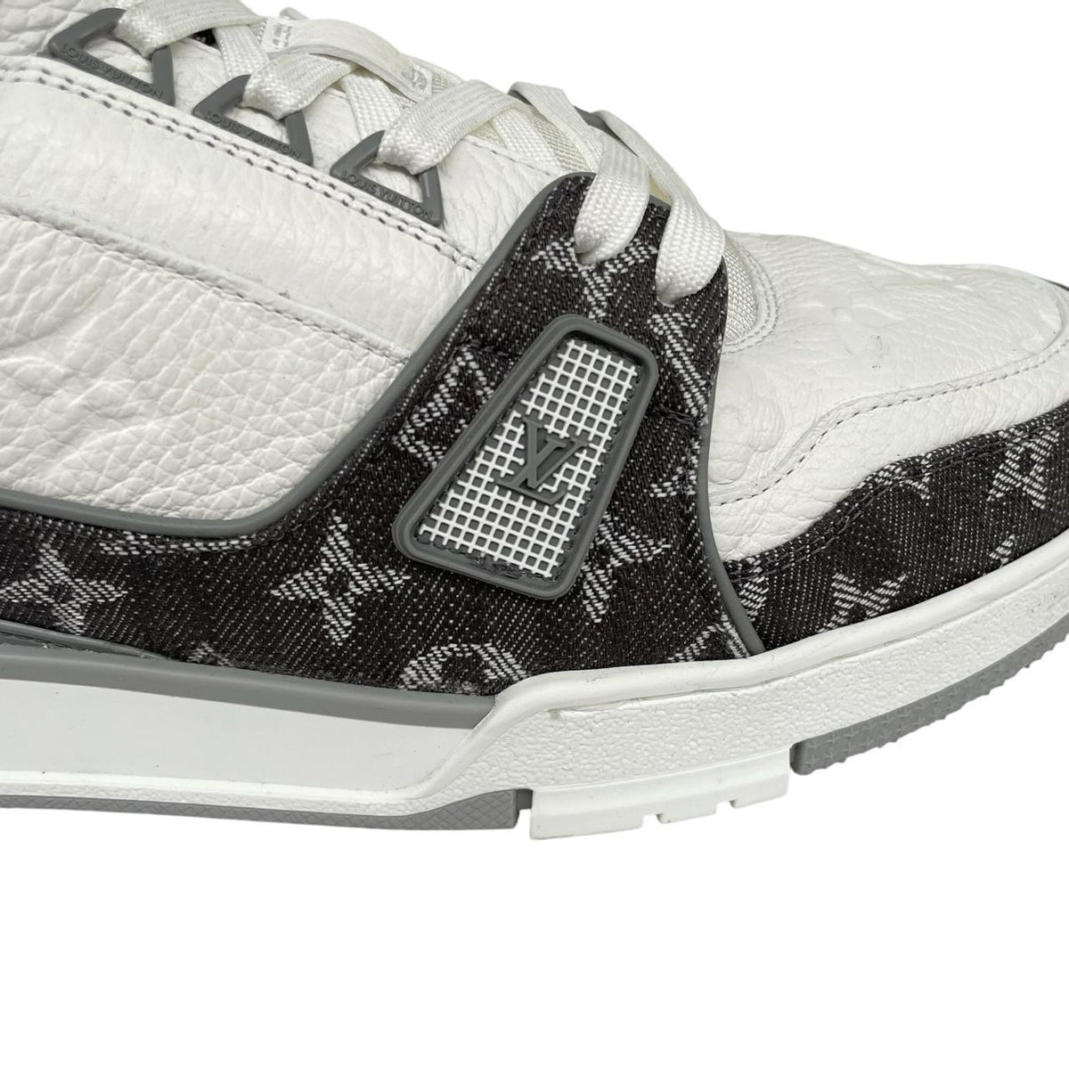 Louis Vuitton grey and white trainers with monogram pattern and leather accents.