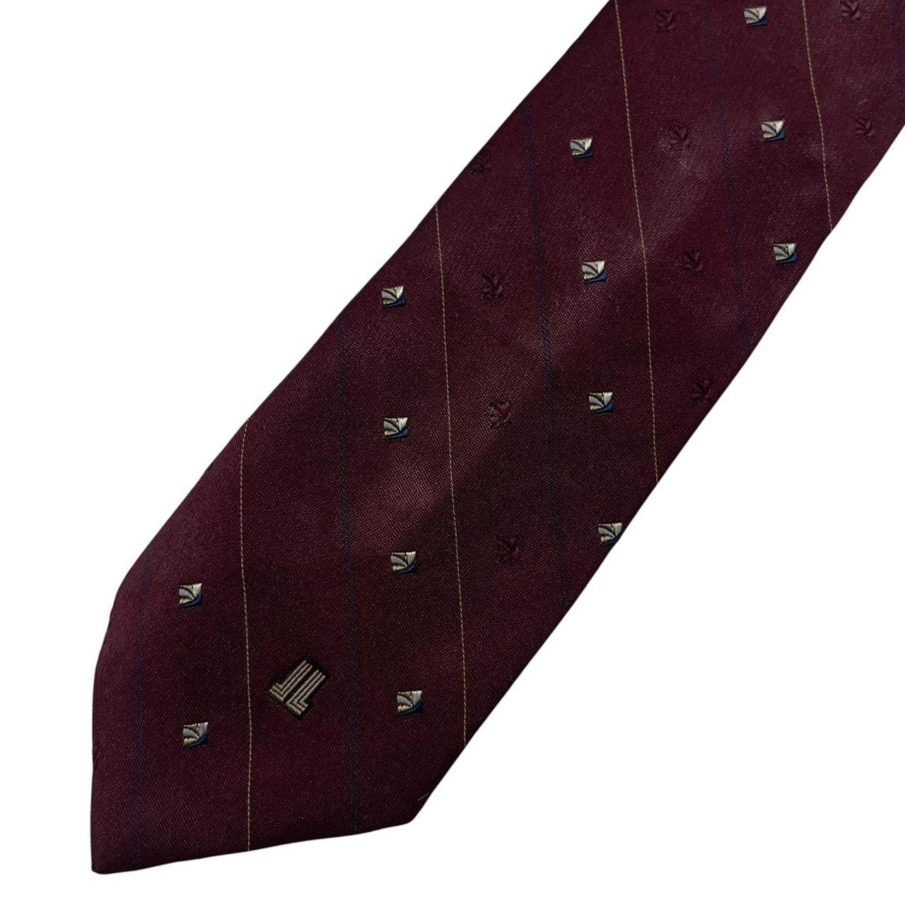 Lanvin burgundy silk tie featuring logo print and smooth texture.